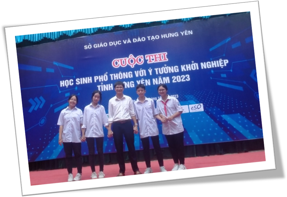 A group of people standing in front of a banner  Description automatically generated